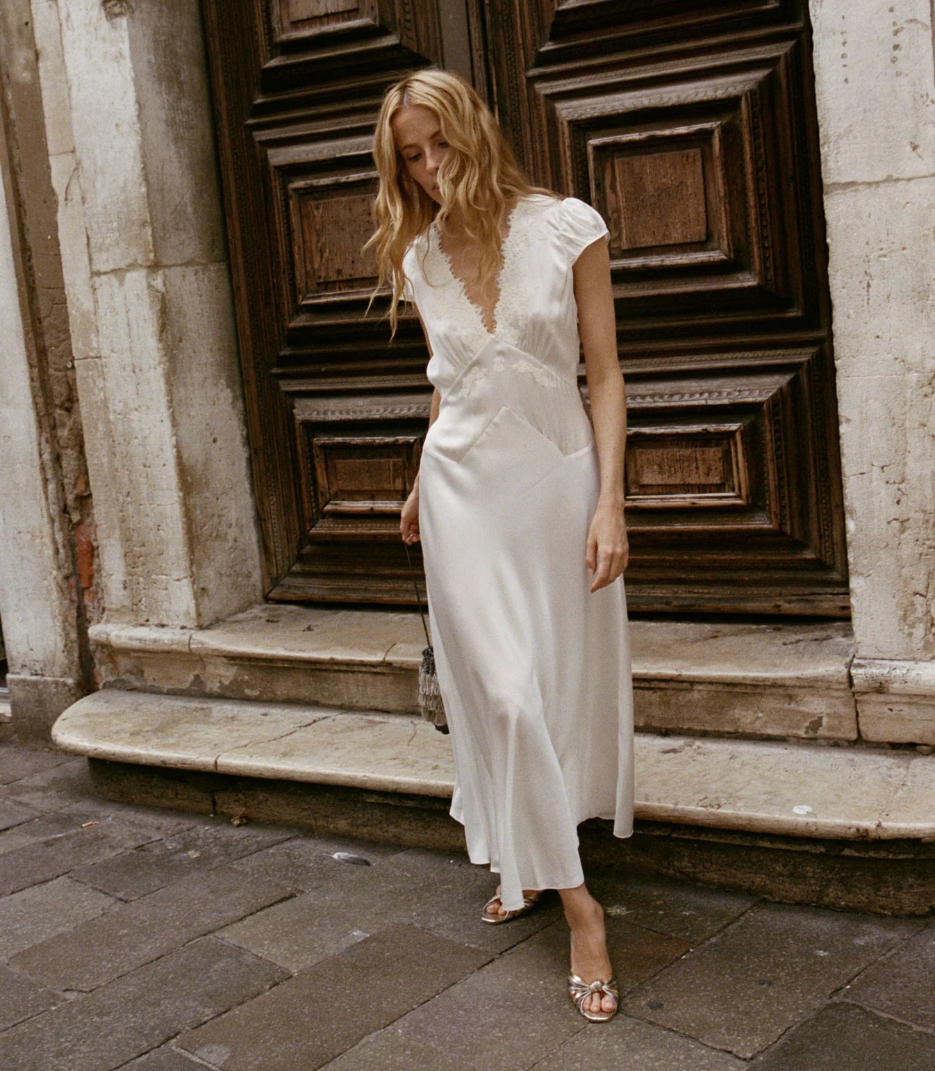 Slip into timeless elegance with the Coraline Dress by Doen, a 1930s-inspired masterpiece crafted from luxurious buttery silk satin. Gathered cap sleeves and a daring plunging V-neckline frame your silhouette, while intricate embroidered scallop lace adds vintage glamour. The fitted bodice features an invisible side seam zipper for seamless styling, paired with an adjustable back waist tie for a personalized fit. 