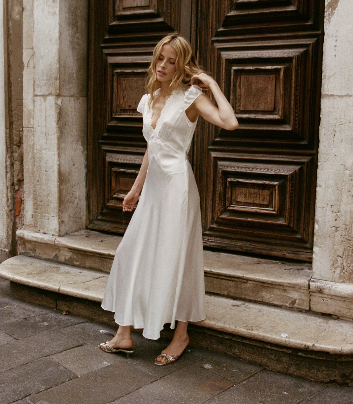 Slip into timeless elegance with the Coraline Dress by Doen, a 1930s-inspired masterpiece crafted from luxurious buttery silk satin. Gathered cap sleeves and a daring plunging V-neckline frame your silhouette, while intricate embroidered scallop lace adds vintage glamour. The fitted bodice features an invisible side seam zipper for seamless styling, paired with an adjustable back waist tie for a personalized fit. 