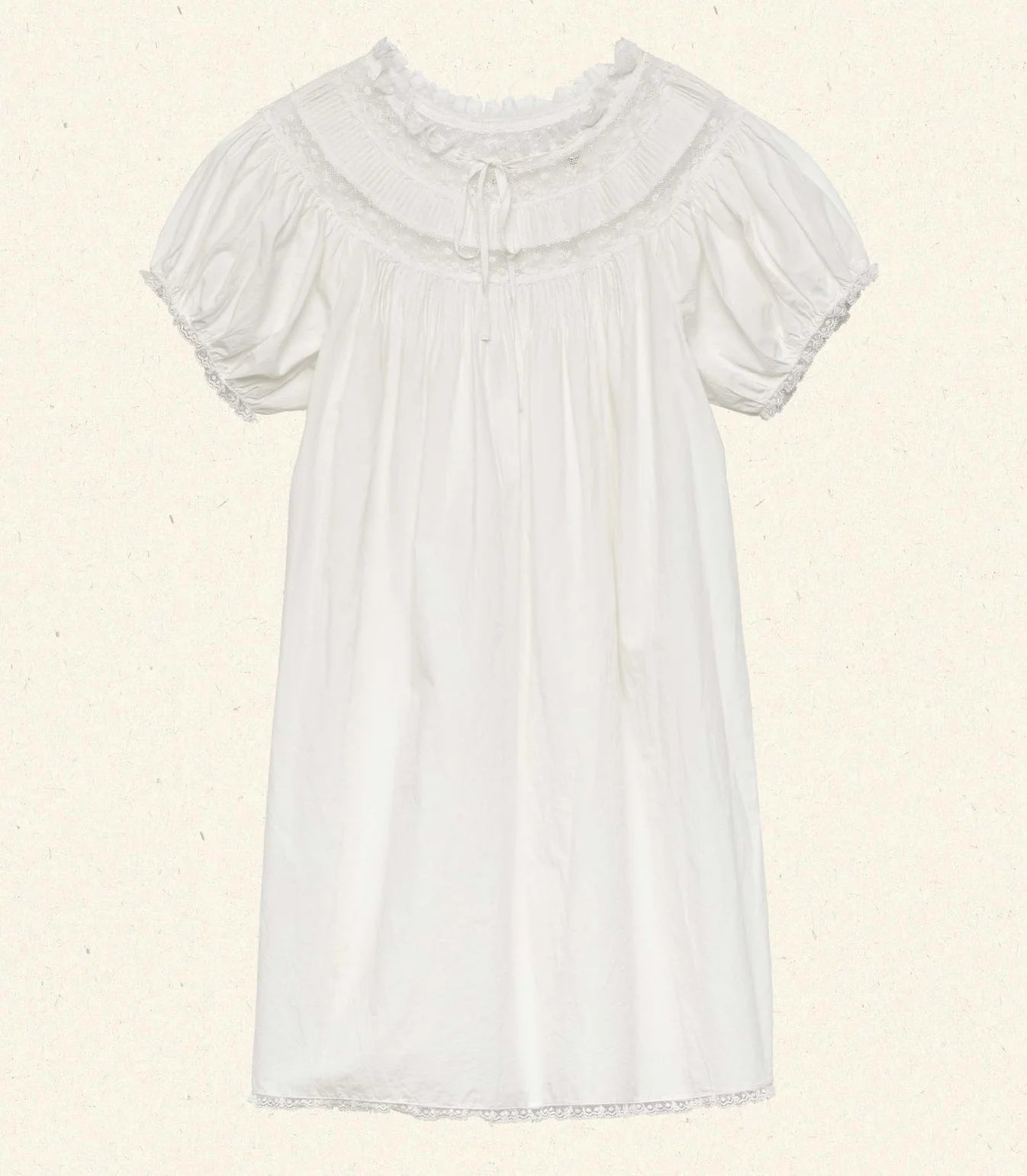 The Daphne Dress by Doen combines refined craftsmanship with effortless style, made from crisp organic cotton poplin for breathability and comfort. Its A-line silhouette and mini-length hem create a light, playful shape, while short puffed sleeves add subtle volume. Detailed with floral scallop lace, delicate pintucks, and a grosgrain ribbon tie at the yoke, this dress is completed with lace trims on the cuffs and hem. Ideal for warm weather occasions, it balances casual ease with elegant detailing.
