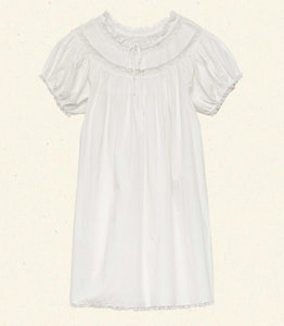 The Daphne Dress by Doen combines refined craftsmanship with effortless style, made from crisp organic cotton poplin for breathability and comfort. Its A-line silhouette and mini-length hem create a light, playful shape, while short puffed sleeves add subtle volume. Detailed with floral scallop lace, delicate pintucks, and a grosgrain ribbon tie at the yoke, this dress is completed with lace trims on the cuffs and hem. Ideal for warm weather occasions, it balances casual ease with elegant detailing.