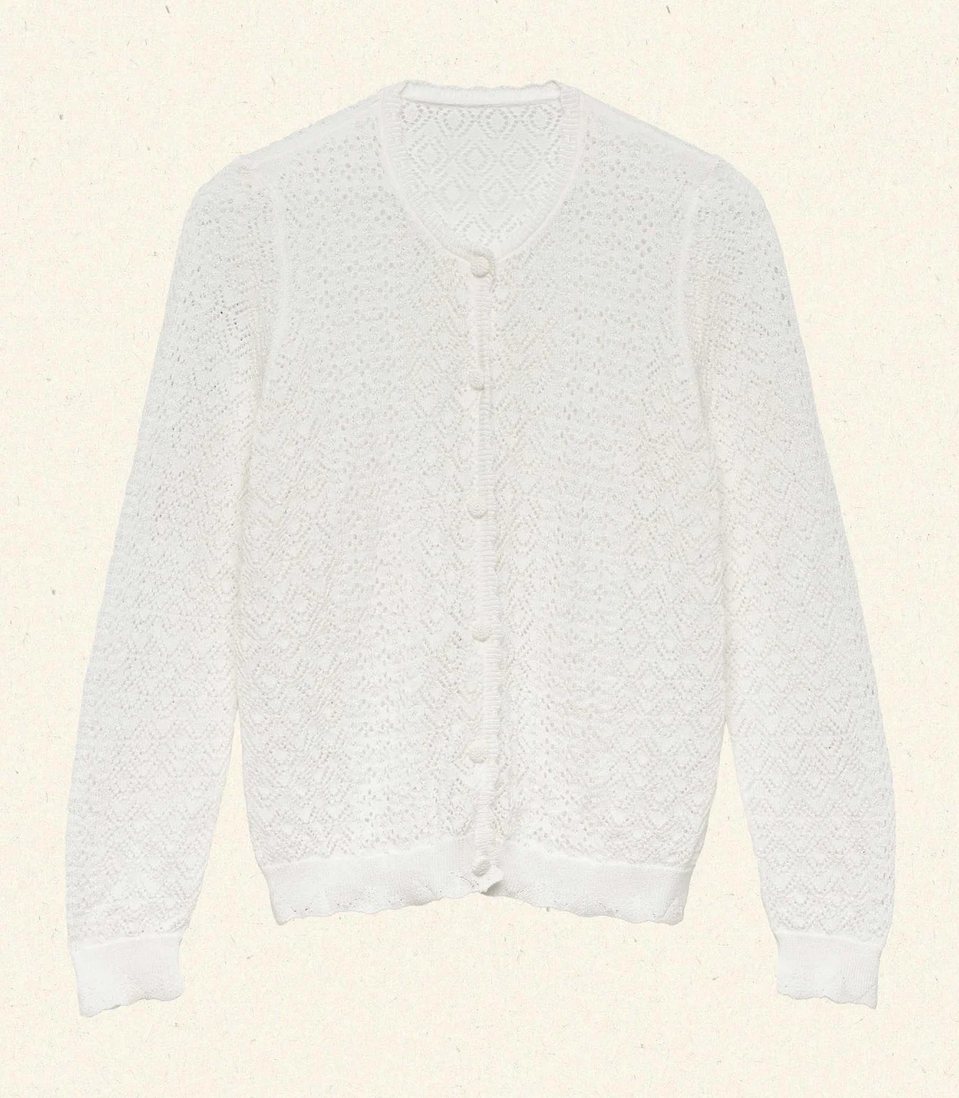 The Diane Cardigan by Doen is a wardrobe essential that effortlessly elevates any outfit with understated sophistication. Its intricate pointelle design draws inspiration from Victorian bobbin lace, creating visual interest while maintaining an airy, breathable feel. Crafted from a luxurious viscose blend, this cardigan drapes gracefully without excess weight, making it perfect for layering across seasons. 