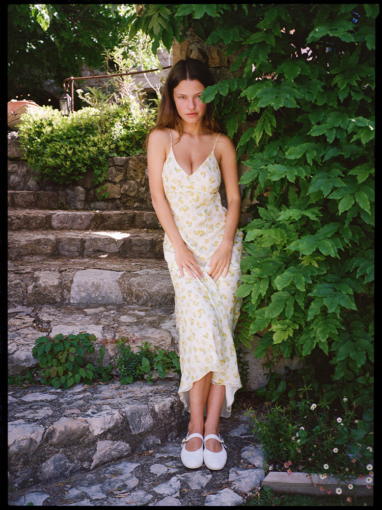 Indulge in the ethereal elegance of the Eugenie Dress in Lemon. The V-neck and soft lemon print portray a romantic and feminine vibe. Perfect for a holiday lunch or a sensual evening out, this dress will elevate your style with its delicate, yet chic design. Pair with Mary Janes or strappy sandals for a luxurious look.