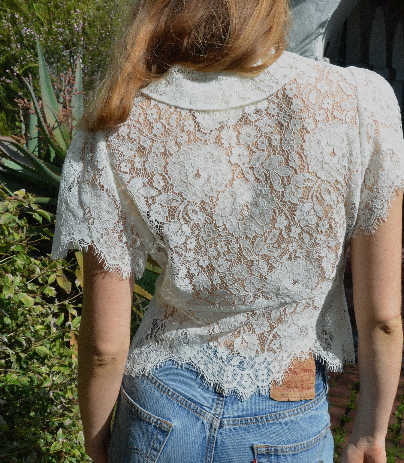 The ‘30s-inspired Fleurance Top is constructed in an intricate allover lace. Dainty buttons with elastic loops extend down the front, while shirring at the sleeves lends volume. Designed to let the light shine through, the Fleurance can be paired with a bra like our Idalia, or with a bikini top on a warm weather getaway.