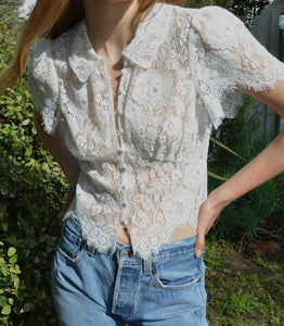 The ‘30s-inspired Fleurance Top is constructed in an intricate allover lace. Dainty buttons with elastic loops extend down the front, while shirring at the sleeves lends volume. Designed to let the light shine through, the Fleurance can be paired with a bra like our Idalia, or with a bikini top on a warm weather getaway.