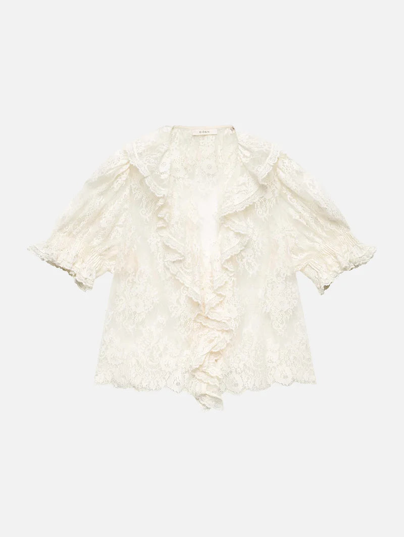 The Henri Lace Top in Sea Salt by Doen brings timeless elegance to your wardrobe with its intricate chantilly-inspired lace and romantic Edwardian details. A plunging V-neckline is beautifully framed by cascading lace-trimmed ruffles that flow down the bodice, while delicate clustered pintucks add texture to the yoke, back, and short puffed sleeves. Hidden starburst buttons line the center front for a polished finish. 