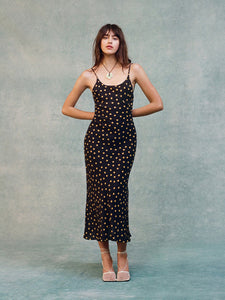 Indulge in the effortless elegance of the Iggy Dress. The 90's inspired slip dress features a flattering ankle length and fish-tail hem, with a scooped bust and low back for a touch of allure. Adjustable back straps ensure the perfect fit, while the bias cut skirt drapes beautifully in 100% silk crepe. No lining needed for a sleek and luxurious feel.