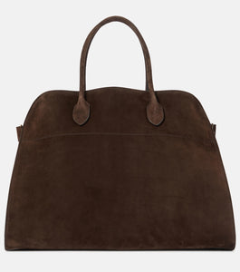 Discover the ultimate in luxurious and everyday style with The Row's Soft Margaux 17 suede tote. Expertly crafted in Italy from supple mocha brown suede, this bag features two rolled top handles, gusseted sides, and a spacious canvas lining. Upgrade your wardrobe with this effortlessly chic and versatile bag.