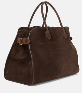 Discover the ultimate in luxurious and everyday style with The Row's Soft Margaux 17 suede tote. Expertly crafted in Italy from supple mocha brown suede, this bag features two rolled top handles, gusseted sides, and a spacious canvas lining. Upgrade your wardrobe with this effortlessly chic and versatile bag.