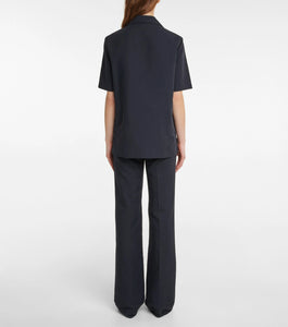 Experience effortless elegance with the Bernardine cotton shirt by The Row, meticulously crafted from pure, finely woven cotton. Featuring a spread collar and an open partial placket, this shirt offers a breezy fit that's perfect for warm weather. Its understated design reflects The Row's commitment to quality and timeless style, making it a versatile addition to your summer wardrobe.