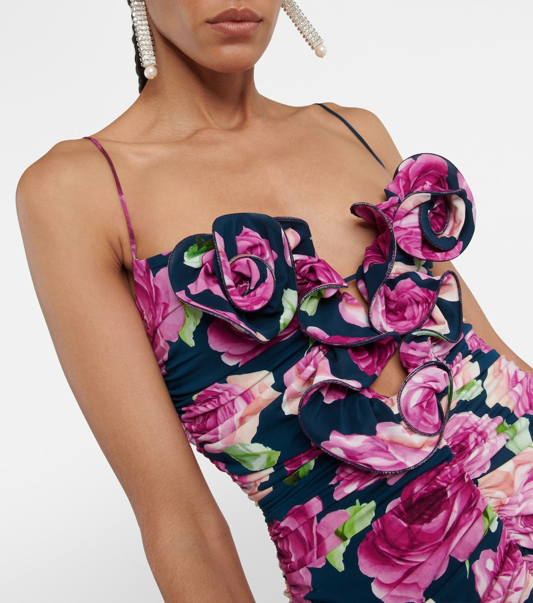 Indulge in pure femininity with Magda Butrym's Floral Ruched Minidress. This exquisite piece boasts a body-hugging silhouette with an all-over ruched texture that adds depth and dimension. Signature rosettes on the bust elevate the playful proportions of this luxurious minidress. Elevate your wardrobe with this sophisticated and exclusive piece.