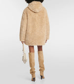 Load image into Gallery viewer, Elevate your style with ease and comfort in this Marant Etoile hooded coat. Crafted with ultra-soft faux-fur and a cozy funnel neck, this beige coat features toggles and side pockets for a functional touch. Perfect for a chic and effortless look. Worn by Emily in Paris.
