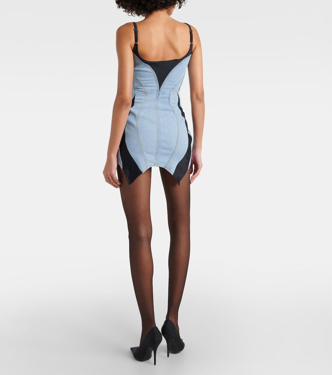 This MUGLER Blue &amp; Black Paneled Denim Minidress features a unique splicing design, adding a touch of sexy and alluring charm to your wardrobe. The backless halter style highlights your figure, while the slim fit enhances your silhouette. Perfect for a night out or special occasion.