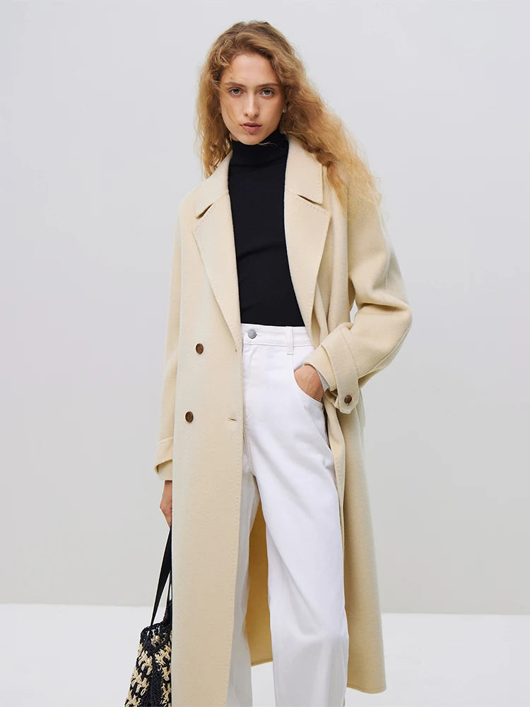 Introducing the Daneela Trench Coat, the epitome of winter elegance. Crafted from 100% wool, this long woolen jacket features a notched collar and double-breasted design, exuding sophistication and style. Complete with a flattering belt decoration, embrace your inner fashionista with this must-have piece.