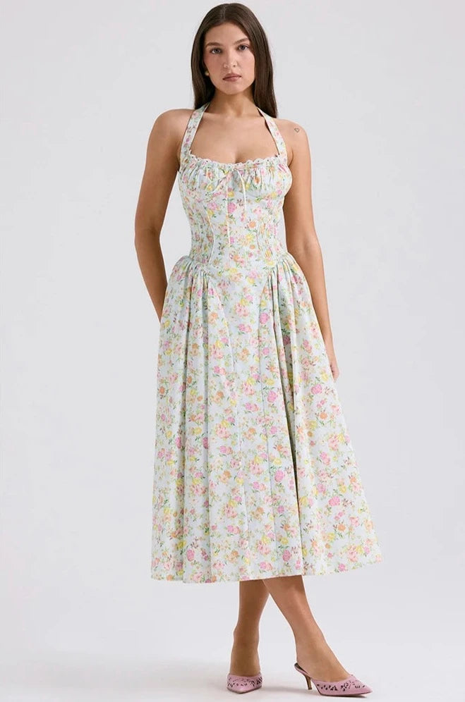 Adabella midi sundress is printed with colourful meadow flowers in full bloom that has us dreaming of Spring sunshine and balmy Summer days. Cut from a stretch cotton-rich fabric, it has a prettily gathered bustier neckline with wide self tie halter straps and a flattering fitted bodice. The voluminous midi skirt has a gorgeous floaty feel that's filled with soft tulle to hold the feminine shape beautifully. It zips to the back for easy on and is of course fully lined for comfort.