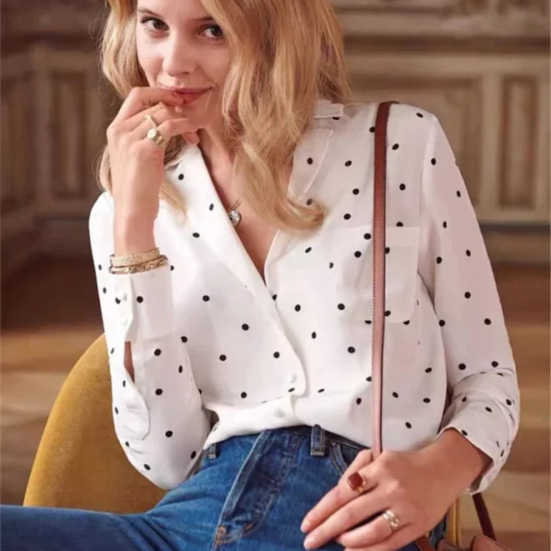 Introducing the Blouse Florence - a luxurious silk top that combines retro polka dots with a modern lapel and V-neck design. The soft waxy texture and heavy sand washing give it a unique, vintage feel. With long sleeves, this shirt is perfect for any occasion and is a must-have for every stylish woman.