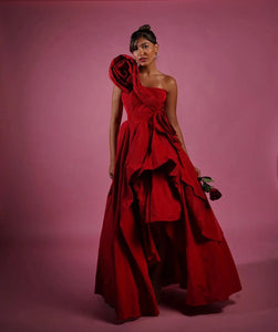 Elevate your prom night with our Gown Teresa. This beautiful red floral dress is crafted with delicate 3D flowers and a one-shoulder design, making it perfect for any special occasion. The asymmetrical cut adds a touch of uniqueness, while the long length exudes elegance. Stand out in style and grace with this pretty prom gown.