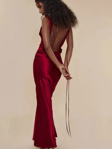 This satin backless bandage dress features spaghetti straps and a v-neck design, making it a sexy and stylish choice for any occasion. The maxi length adds an elegant touch, while the bandage material provides a flattering fit. Perfect for making a statement at any event.