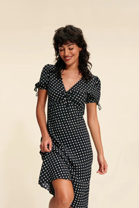 Welcome summer with style with our Dress Sybillia. This beautiful A-line dress features a trendy polka dot pattern and a flattering V-neck design. The drawstring waist allows for a customized fit, while the bubble short sleeves add a playful touch. Perfect for any occasion, this dress will make you stand out and feel confident all summer long.