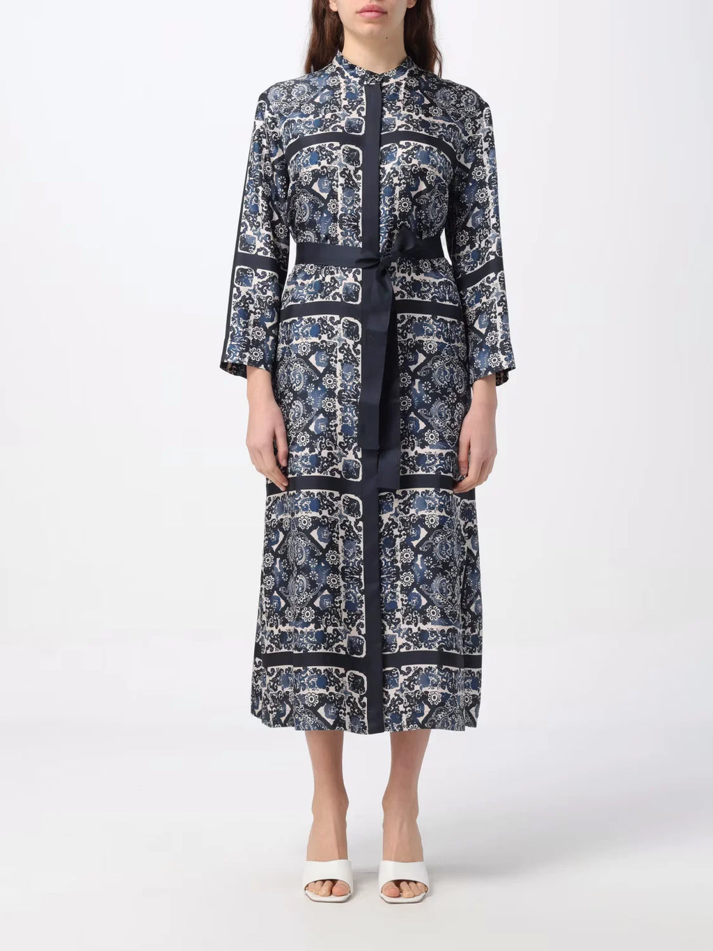 Elevate your style with the Max Mara Printed Silk Dress. The caftan-style dress is crafted from exquisite, printed silk that gives it a beautiful flow. With its slightly flared silhouette, mandarin collar, and matching belt, this dress accentuates your waist for a flattering look. Finished with hidden mother-of-pearl buttons and a back pleat for added elegance.