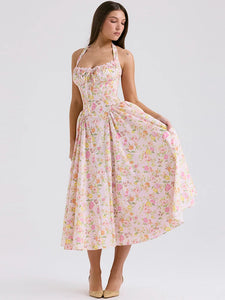 Adabella midi sundress is printed with colourful meadow flowers in full bloom that has us dreaming of Spring sunshine and balmy Summer days. Cut from a stretch cotton-rich fabric, it has a prettily gathered bustier neckline with wide self tie halter straps and a flattering fitted bodice. The voluminous midi skirt has a gorgeous floaty feel that's filled with soft tulle to hold the feminine shape beautifully. It zips to the back for easy on and is of course fully lined for comfort.