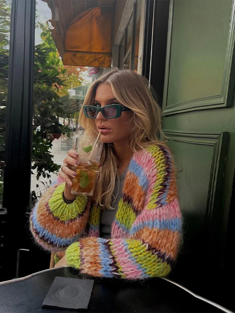 Enhance your wardrobe with the Cardigan Jade. Made with colorful, striped crochet knit and lantern sleeves, this cardigan is perfect for casual wear. The front open design adds versatility to any outfit. Stay warm and stylish with the Cardigan Jade.