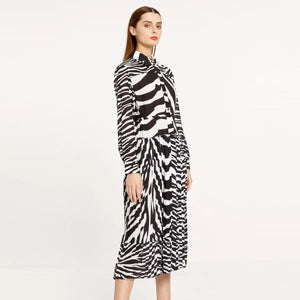 Elevate your style with our Poplin Chemisier Dress. This midi dress features a unique zebra pattern and pleated design, adding a touch of sophistication to your wardrobe. Perfect for any occasion, this dress is sure to make a statement.