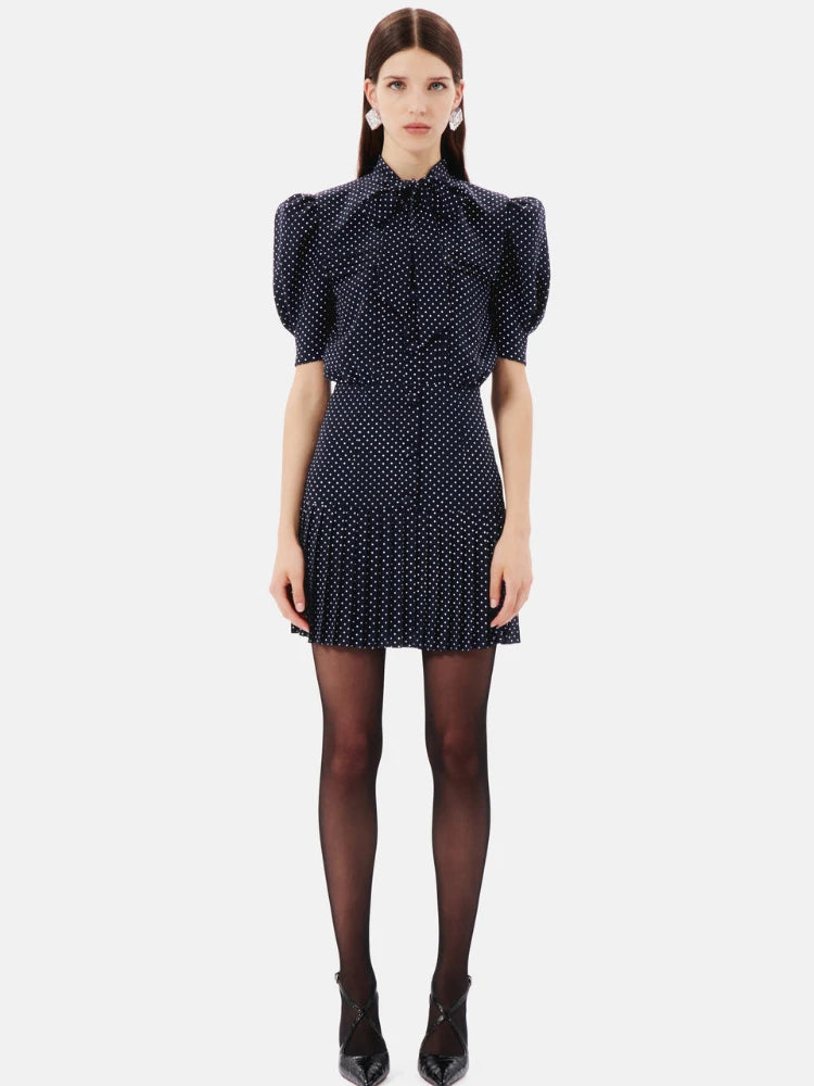 Experience elegance and luxury with the Alessandra Rich polka-dot pleated silk dress. Crafted from high-quality silk, this dress features a beautiful polka-dot pattern and delicate pleating, creating a timeless and sophisticated look. Perfect for any special occasion, make a statement in this exquisite dress.