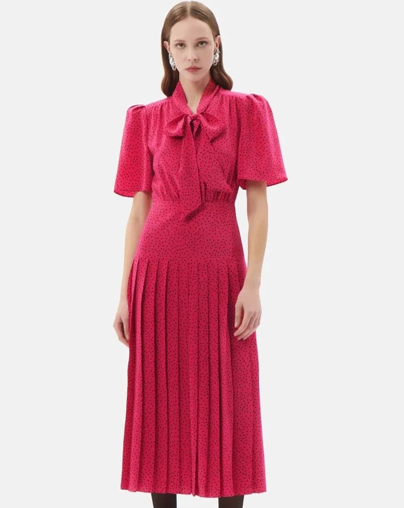 Step into timeless elegance with the Alessandra Rich polka-dot pleated silk dress. Made from luxurious silk, this dress features delicate pleats and a charming polka-dot pattern, perfect for any occasion. Stay effortlessly chic and comfortable all day long while exuding a classic style statement.