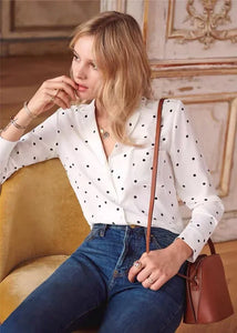 Introducing the Blouse Florence - a luxurious silk top that combines retro polka dots with a modern lapel and V-neck design. The soft waxy texture and heavy sand washing give it a unique, vintage feel. With long sleeves, this shirt is perfect for any occasion and is a must-have for every stylish woman.