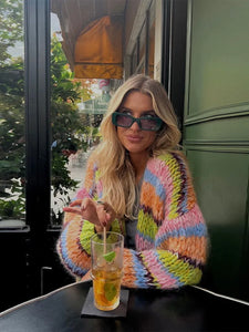 Enhance your wardrobe with the Cardigan Jade. Made with colorful, striped crochet knit and lantern sleeves, this cardigan is perfect for casual wear. The front open design adds versatility to any outfit. Stay warm and stylish with the Cardigan Jade.