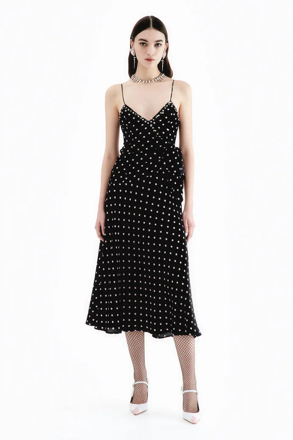 This high-quality designer slip dress, adorned with a playful polka dot print and finished with a delicate bow, is a top-of-the-line addition to any wardrobe. Handmade by industry experts, this Alessandra Rich dress offers a slinky, sophisticated silhouette perfect for any occasion.