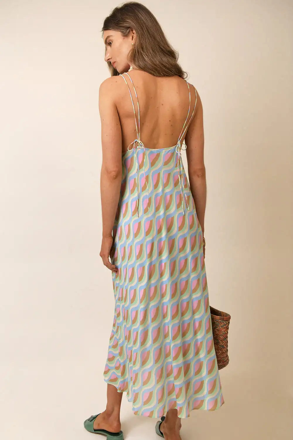 Introducing the RIXO Dress, a high-quality designer dress with a printed skirt. Handmade with precision and care, this dress features a long sling design and needle and thread detail. Elevate your wardrobe with this stylish and unique piece.