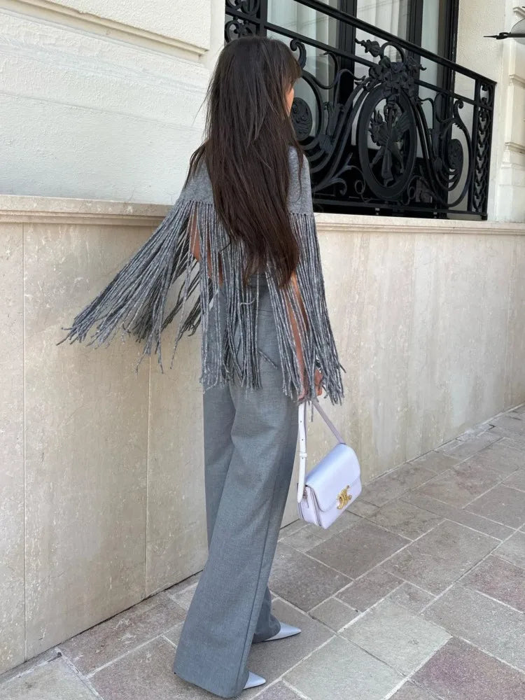 This elegant Fringed Knitted Cape is the perfect addition to any fashion-forward wardrobe. Crafted with a slim cut and tassel hem, the high neck and long fringe detail add an element of sophistication. Stay stylish and comfortable with this must-have piece for any occasion.