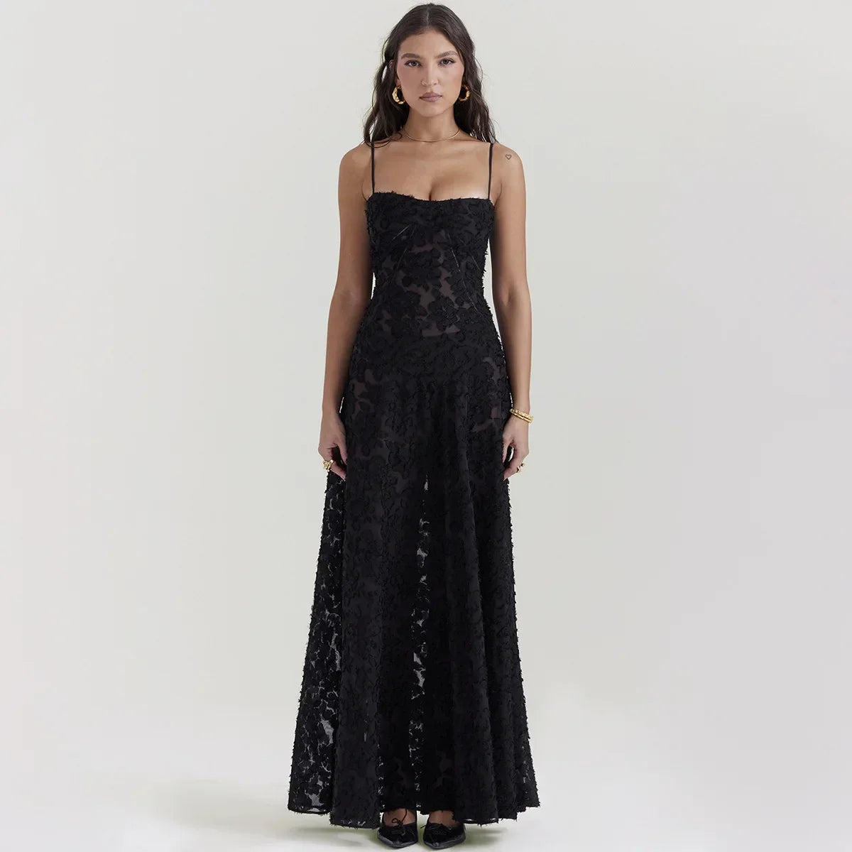 The Dress Seren is a stunning addition to any formal occasion. With its elegant and beautiful black appliques, this maxi dress is sure to turn heads. Perfect for dancing parties, its long silhouette exudes sophistication and luxury. Elevate your wardrobe with this must-have dress.