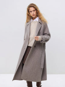 Introducing the Daneela Trench Coat, the epitome of winter elegance. Crafted from 100% wool, this long woolen jacket features a notched collar and double-breasted design, exuding sophistication and style. Complete with a flattering belt decoration, embrace your inner fashionista with this must-have piece.