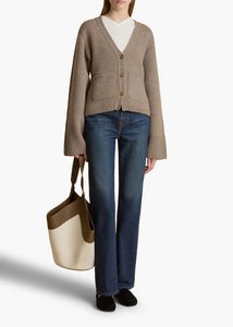 Accented by fisherman's rib trim, patch pockets and tortoiseshell buttons, this deep V-neck cardigan hugs the body in medium-weight cashmere selected for its exceptional softness and sturdy texture. The fitted silhouette is balanced by relaxed, elongated sleeves. This richly hued cardigan from Khaite in soft, sumptuous cashmere is as cozy as it is elegant. The V-neck is perfect as an off-the-shoulder piece for both day and evening wear. This cardigan has a V-neck and fastens with a button in the front. 