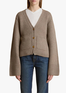 Accented by fisherman's rib trim, patch pockets and tortoiseshell buttons, this deep V-neck cardigan hugs the body in medium-weight cashmere selected for its exceptional softness and sturdy texture. The fitted silhouette is balanced by relaxed, elongated sleeves. This richly hued cardigan from Khaite in soft, sumptuous cashmere is as cozy as it is elegant. The V-neck is perfect as an off-the-shoulder piece for both day and evening wear. This cardigan has a V-neck and fastens with a button in the front. 