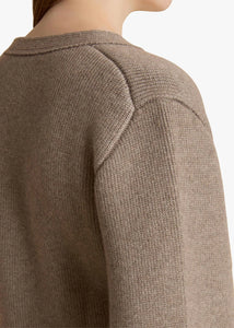 Accented by fisherman's rib trim, patch pockets and tortoiseshell buttons, this deep V-neck cardigan hugs the body in medium-weight cashmere selected for its exceptional softness and sturdy texture. The fitted silhouette is balanced by relaxed, elongated sleeves. This richly hued cardigan from Khaite in soft, sumptuous cashmere is as cozy as it is elegant. The V-neck is perfect as an off-the-shoulder piece for both day and evening wear. This cardigan has a V-neck and fastens with a button in the front. 