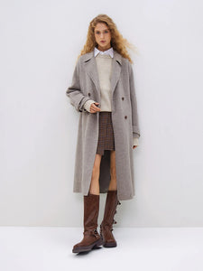 Introducing the Daneela Trench Coat, the epitome of winter elegance. Crafted from 100% wool, this long woolen jacket features a notched collar and double-breasted design, exuding sophistication and style. Complete with a flattering belt decoration, embrace your inner fashionista with this must-have piece.