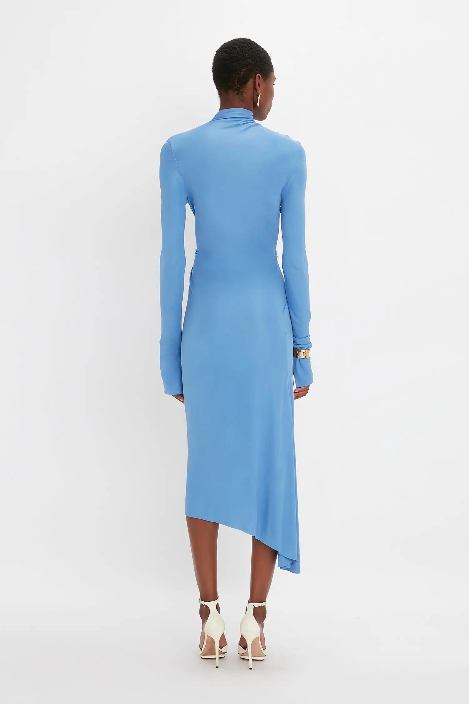 Experience luxury and sophistication with our Victoria Beckham asymmetric draped midi dress. Handmade by a high-end designer, this dress boasts a beautiful blue color and is crafted with the finest silk. Elevate your style with this stunning piece that exudes elegance and grace.