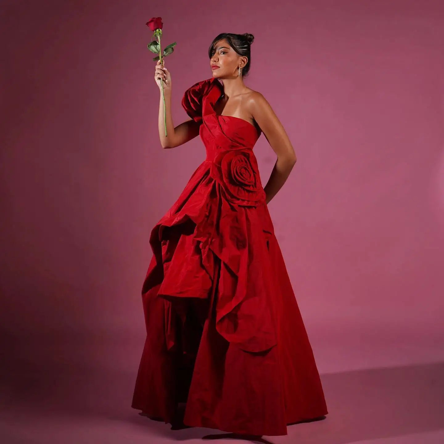 Elevate your prom night with our Gown Teresa. This beautiful red floral dress is crafted with delicate 3D flowers and a one-shoulder design, making it perfect for any special occasion. The asymmetrical cut adds a touch of uniqueness, while the long length exudes elegance. Stand out in style and grace with this pretty prom gown.