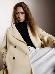 Introducing the Daneela Trench Coat, the epitome of winter elegance. Crafted from 100% wool, this long woolen jacket features a notched collar and double-breasted design, exuding sophistication and style. Complete with a flattering belt decoration, embrace your inner fashionista with this must-have piece.