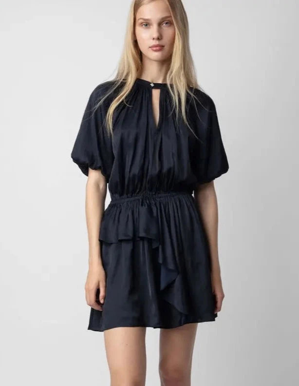 Elevate your autumn wardrobe with Dress Charlotte. Featuring a flattering V-neck, ruffled detail, and elastic waistband for a comfortable fit. The puff sleeves and solid color add an elegant touch to this mini dress. Perfect for any occasion, this dress will make you feel confident and stylish.