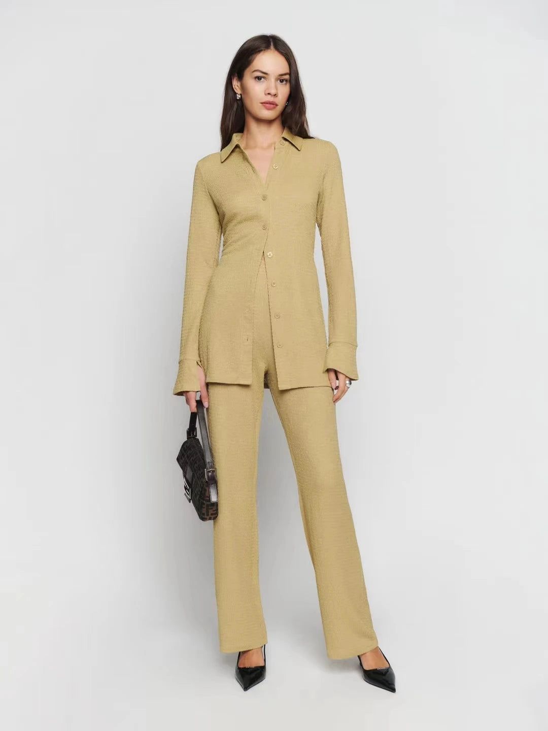 Upgrade your wardrobe with the stylish and comfortable Ensemble Rosario. This women's slim knit set includes a single breasted, simple casual shirt top and high waist long pants, perfect for a casual day out or a night in. Stay fashionable and comfortable with this versatile ensemble.