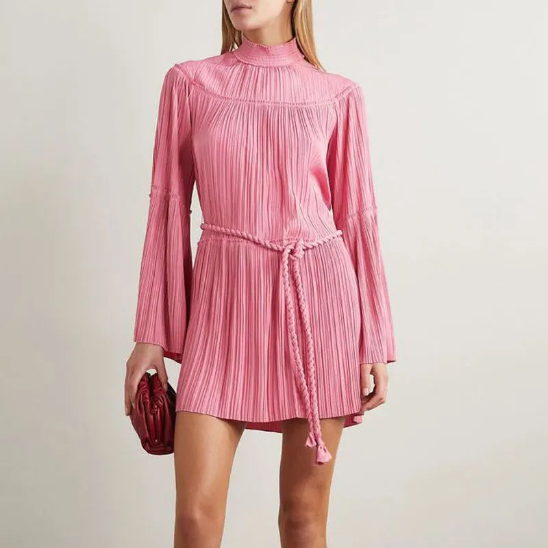 This stunning Tressa Belted Plissé Mini Dress is a must-have for any fashion-forward woman! The pleated design adds texture and movement to this loose-fitting dress, while the included sashes allow for a customizable fit. Perfect for any occasion, this dress will have you feeling confident and stylish wherever you go!