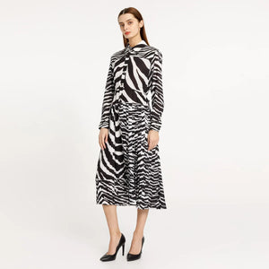 Elevate your style with our Poplin Chemisier Dress. This midi dress features a unique zebra pattern and pleated design, adding a touch of sophistication to your wardrobe. Perfect for any occasion, this dress is sure to make a statement.