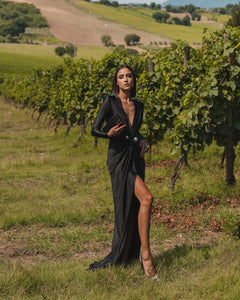 Step out in style with the Robe Elisa. This elegant deep V-neck maxi dress is perfect for any party or club setting. With long sleeves and a sultry thigh-high split, you'll be sure to turn heads. The ruched detailing adds a touch of fashion to this sexy and sophisticated gown. Elevate your wardrobe with this must-have outfit for women.