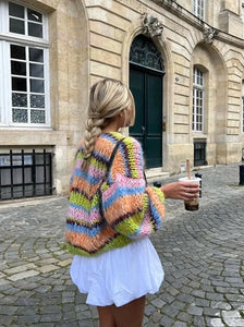 Enhance your wardrobe with the Cardigan Jade. Made with colorful, striped crochet knit and lantern sleeves, this cardigan is perfect for casual wear. The front open design adds versatility to any outfit. Stay warm and stylish with the Cardigan Jade.