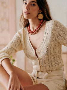 Indulge in handmade luxury with our new Cardigan Cybelle! Crafted with intricate crochet details, this V-neck cardigan features a flattering silhouette and hollow long sleeves. Perfect for a cozy yet chic look, elevate your style game with this knitted masterpiece.