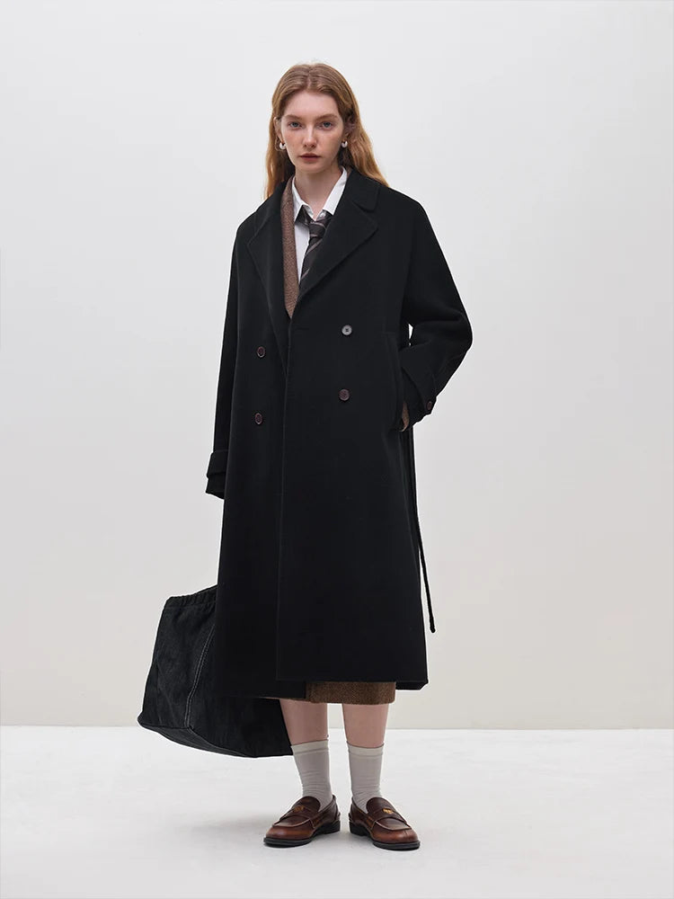 Introducing the Daneela Trench Coat, the epitome of winter elegance. Crafted from 100% wool, this long woolen jacket features a notched collar and double-breasted design, exuding sophistication and style. Complete with a flattering belt decoration, embrace your inner fashionista with this must-have piece.